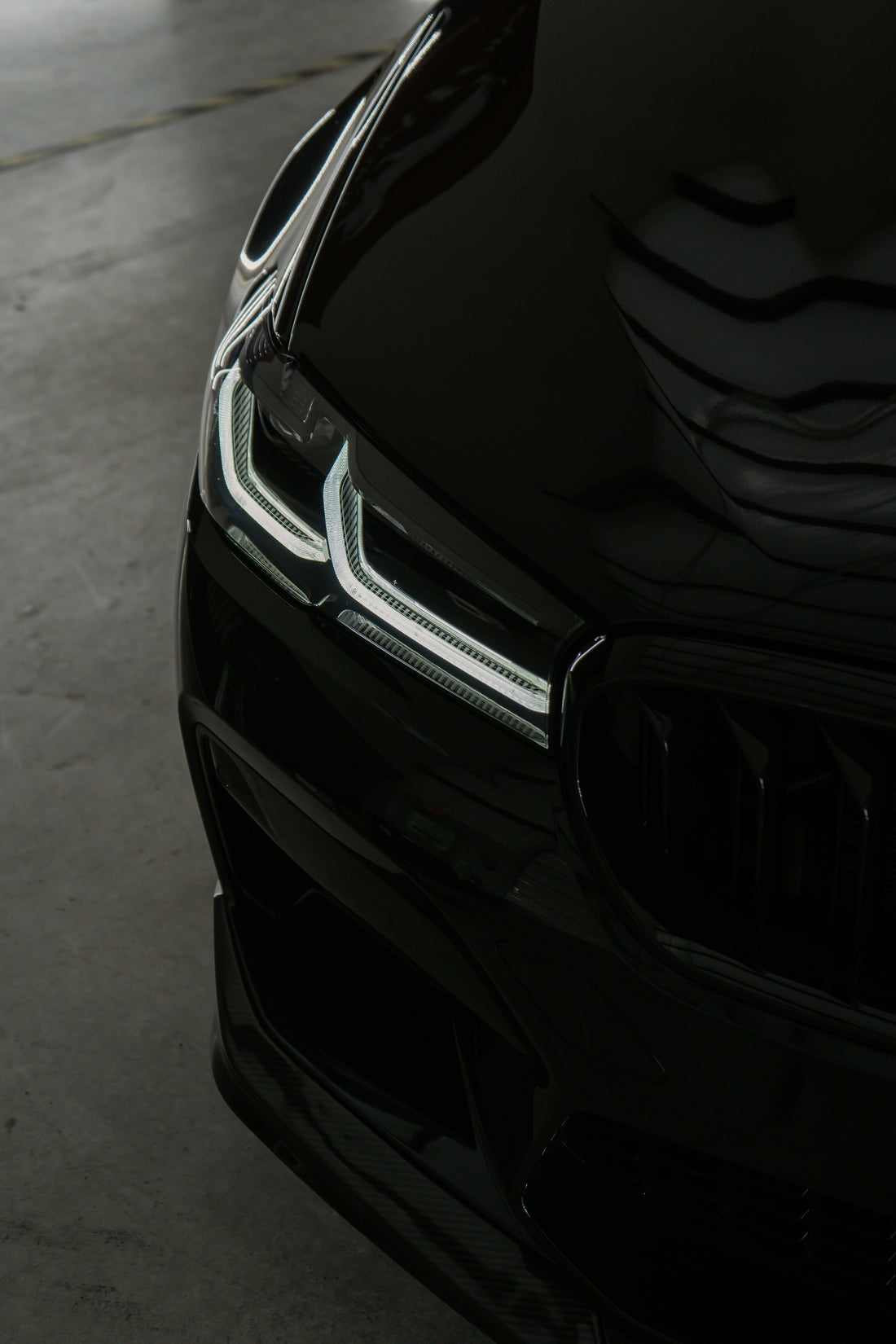 A car coated with ceramic, shining under sunlight, showcasing its glossy, smooth finish and superior protection from the elements.